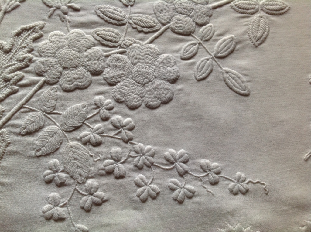 Close-up of detailing on a mountmellick piece, including shamrocks and flowers