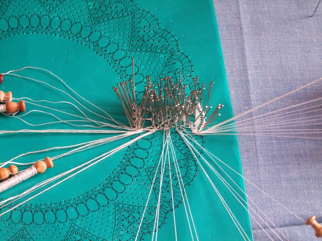 beginning of a bobbin lace piece, with design mapped out